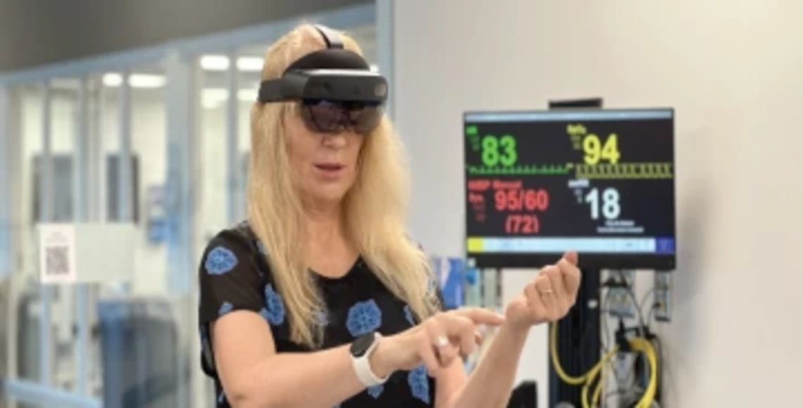 Person wearing VR headset while standing in front of medical device