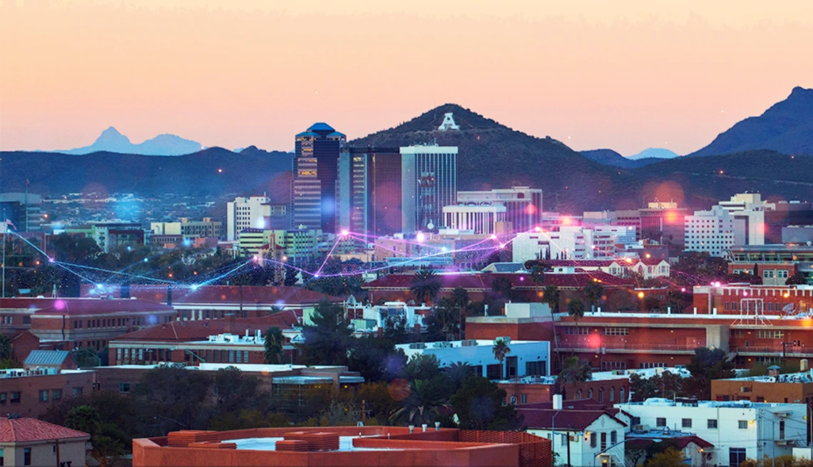 stylized image of the University campus and Tucson skyline with A Mountain in the background. There is an overlay of an abstract data stream.