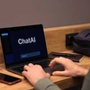 hands typing on a keyboard while the computer screen reads "chatAI"